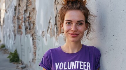 Wall Mural - Young woman with a radiant smile wearing a purple t-shirt with the word 