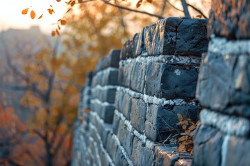 Poster - A stone wall with a tree in the background, suitable for architectural and nature-themed designs