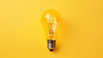 Wall Mural - A bright yellow light bulb on a matching yellow background. Perfect for concepts related to creativity and innovation