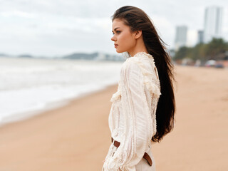 Canvas Print - Fashionable Brunette Woman Enjoying a Serene Beach Sunset