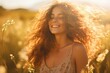 Young happy smiling woman standing in a summer field with golden hour light