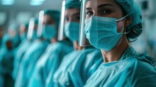 Surgeons Team Wearing Protective Uniforms, Standing In Row And Looking At Camera