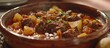 A detailed view of a bowl filled with freshly made and delicious beef goulash placed on a table, showcasing the rich colors and textures of the dish.