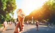 sweet treat: Holding a delicious ice cream cone at a summer park.