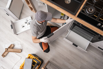 Wall Mural - Kitchen Cabinetmaker Installing Furniture Inside a Apartment