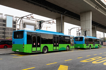 Wall Mural - Electric bus at a stop is charged by pantograph. Clean mobility.