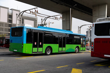 Sticker - Electric bus at a stop is charged by pantograph. Clean mobility.