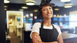© Flamingo Images - Happy confident small business owner standing at her cafe and receiving her customers