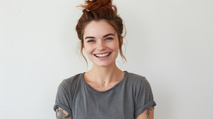 Sticker - A cheerful woman with red hair tied in a bun, laughing joyfully in a casual grey t-shirt, her freckles and bright expression conveying happiness.