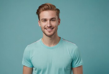 Wall Mural - A happy man in a light blue tee beams at the camera. His upbeat attitude and casual appearance offer a vibe of youthful optimism.