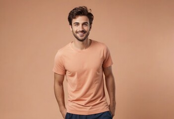 Wall Mural - A smiling man in a casual peach tee poses with ease. His friendly demeanor and stylish look convey approachability and modern fashion sense.