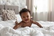 African American baby crawling playing on bed in bedroom Smiling wearing diaper