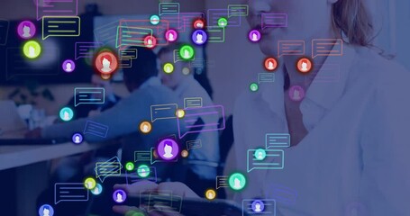 Poster - Animation of media icons over caucasian businesswoman using smartphone over colleagues