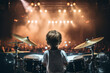 © Tetiana - Image of a little funny boy playing with a drum set made with generative AI
