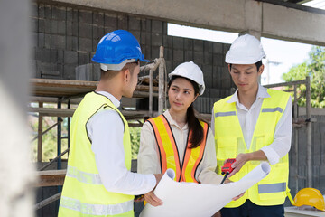 Wall Mural - Civil engineer teams meeting working together wear worker helmets hardhat on construction site in modern city. Foreman industry project manager engineer teamwork. Asian industry professional team