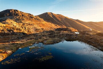 Sunrise shine over Lac Guichard with rocky mountain in autumn at France