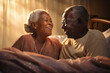 An elderly dark-skinned man and woman lying on a bed together, displaying love and affection