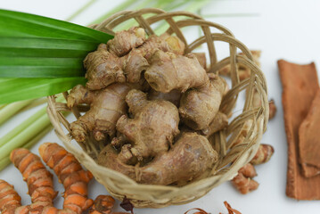 ginger, cinnamon, turmeric, galangal, pandan leaves, lemongrass on a white background