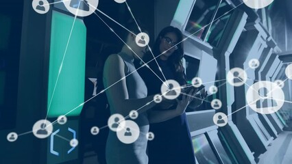Poster - Animation of network of connections with icons over diverse colleagues using laptop