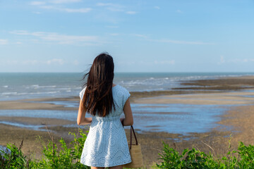 Wall Mural - Back rear view of woman look at the sea beach