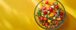 Wholesome quinoa salad with cherry tomatoes and cucumber in a glass bowl on a sunshine yellow background Top view space to copy.