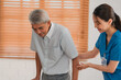 © chokniti - Asian physiotherapist nursing home to support old senior man patient therapy by walker, caregiver nurse help recovery health care with elderly retirement man person at home, health insurance concept
