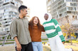 © ADDICTIVE STOCK - Multicultural students laughing together outdoors