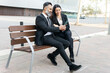 © ADDICTIVE STOCK - Business colleagues sharing a moment on a park bench