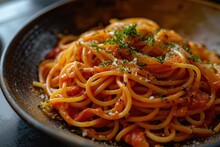 A Bowl Of Spaghetti With Sauce And Parsley