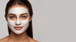 Gorgeous young woman with skin care moisturizing mask on her face, for dewy complexion, removing excess oils from skin, improving the appearance and hydrating skin.