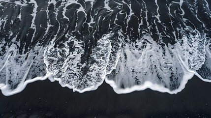 Wall Mural - Black, volcanic beach, Aerial drone view of moody atlantic ocean wave on black sand beach in summer
