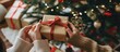 © FINZZ - Hands holding craft paper gift box Romantic holiday celebration with gift box