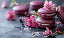 bordeaux colored macarons with pink spring flowers on dark background