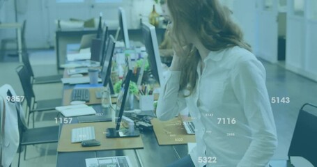 Poster - Animation of data processing over caucasian businesswoman talking on smartphone in office