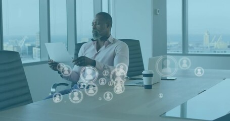 Poster - Animation of media icons over african american businessman reading document in office
