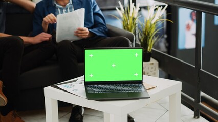 Poster - Laptop showing greenscreen template in small business coworking space office, isolated copyspace display on table. Blank chromakey software on screen, professional executive agency.
