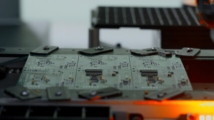 Poster - Close up of industrial background with printed circuit board being assembled with automated robotic arm. Creative. Concept of modern robotic technologies and engineering.