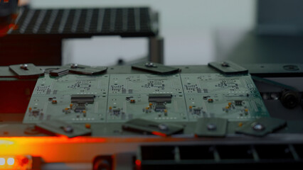 Poster - Close up of industrial background with printed circuit board being assembled with automated robotic arm. Creative. Concept of modern robotic technologies and engineering.