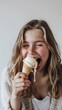 Girl playfully sticking out her tongue to catch a melting drip of ice cream, with a mischievous smile on her face, against a clean white backdrop, generative AI