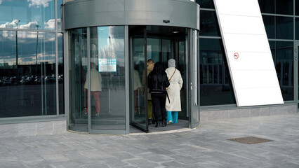 a revolving door in modern building, shopping center. media. glass rotating door, turntable entrance