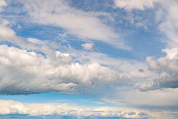 Wall Mural - Dramatic white stormy clouds over a blue sky background