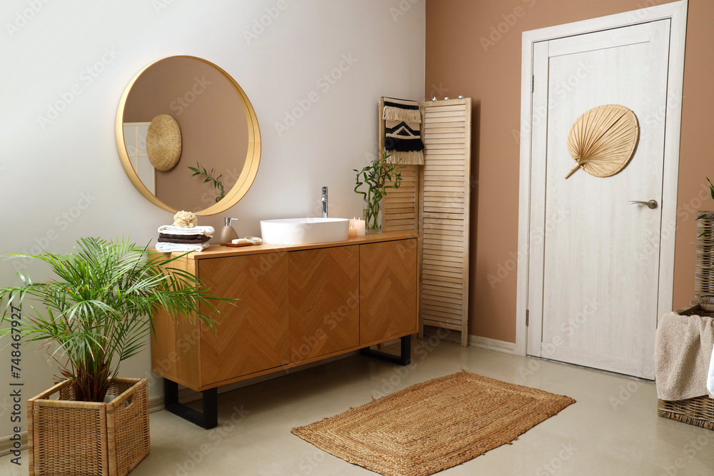 Interior of spa salon with sink, mirror and door