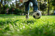 boy runs on grass in park with the ball