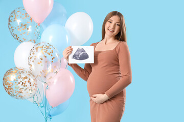 Canvas Print - Young pregnant woman with sonogram image and balloons for baby shower on blue background