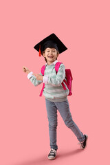 Sticker - Little girl in graduation hat pointing at something on pink background. End of school year