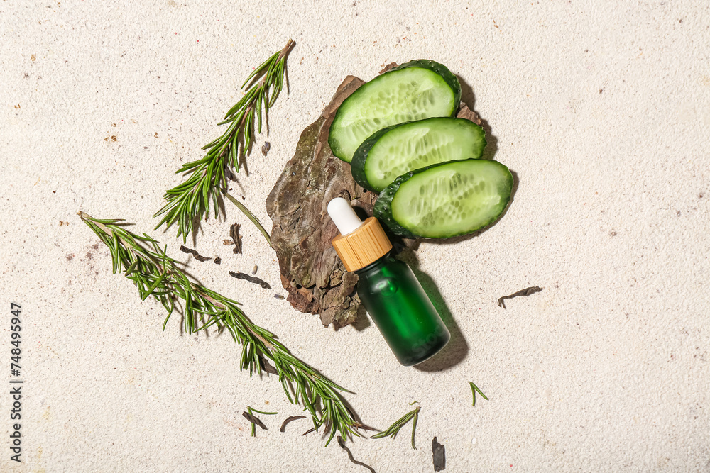 Composition with bottle of essential oil and natural ingredients on light background