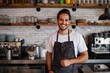 © senyumanmu - Male entrepreneur wearing apron in kitchen at coffee shop