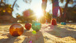 © Keitma - People playing boules on sand with colorful balls on summer holidays