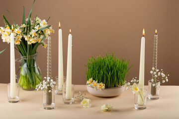 Wall Mural - Novruz table setting with green samani wheat grass with red ribbon, daffodils, candles, kelagai and blooming flowers, spring or new year celebration in Azerbaijan, copy space