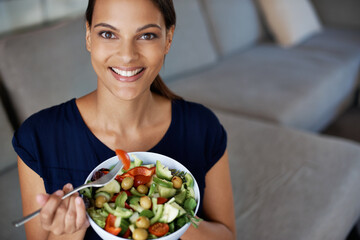 Black woman, portrait and salad for food, eating and diet on sofa, couch and lounge. Vegan lady, happy female person and vegetables for health, nutrition and wellness at home, house and living room